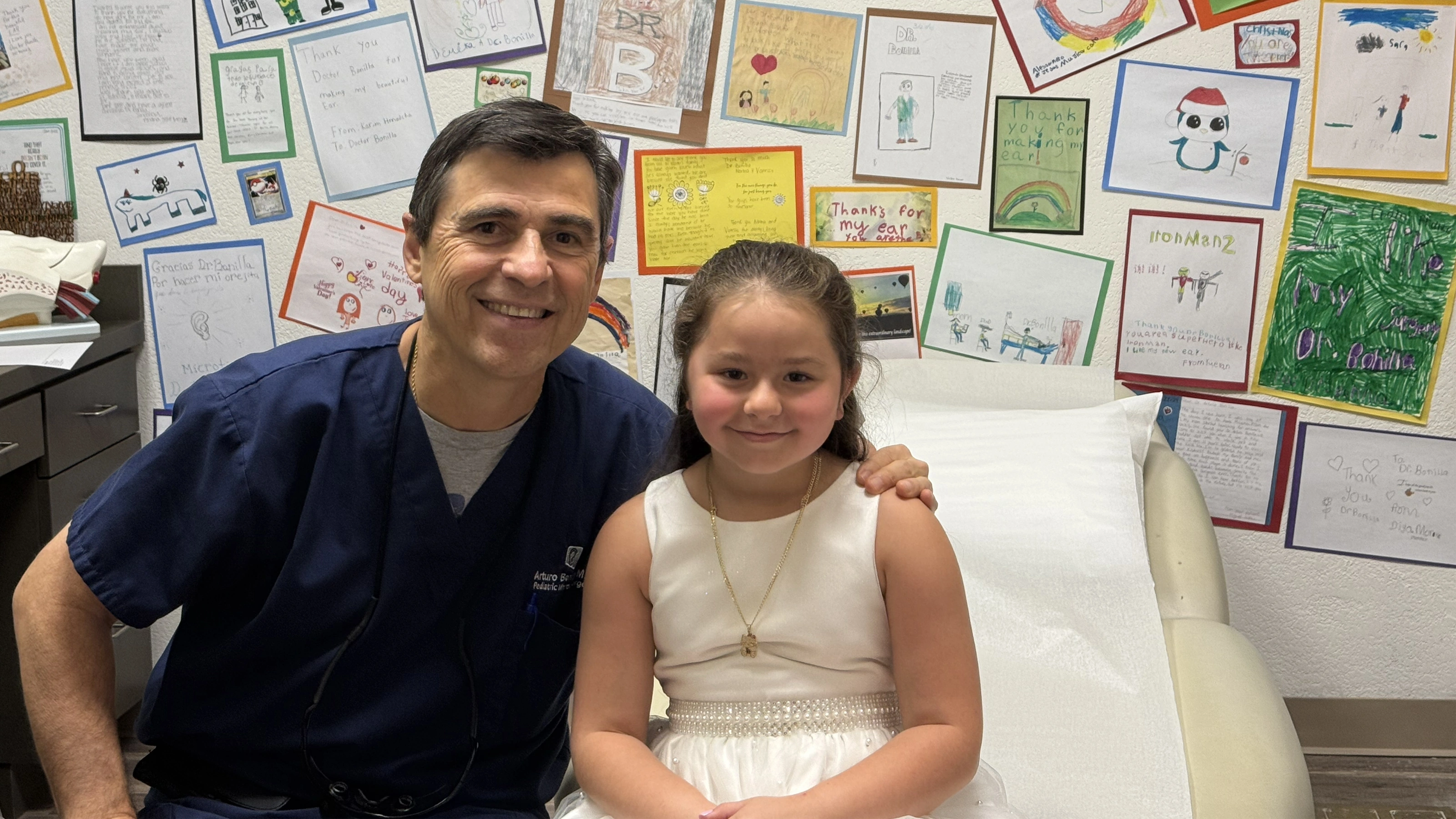 Dr. Arturo Bonilla with a pediatric microtia patient following ear reconstruction at the Microtia &ndash; Congenital Ear Institute in San Antonio, Texas.