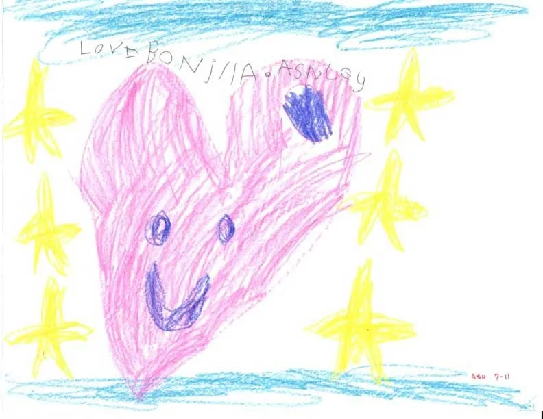 Dibujo colorido de Ashley para el Dr. Bonilla, con un gran corazón rosa sonriente rodeado de estrellas amarillas y nubes azules