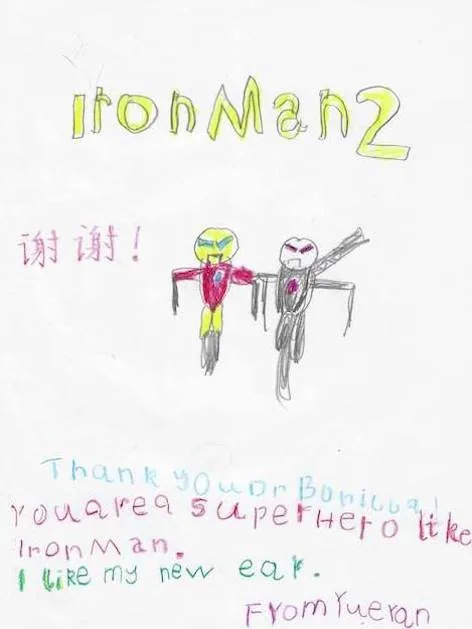 Dibujo infantil de Yueran con personajes de Iron Man 2, caracteres chinos de agradecimiento y el mensaje «Usted es un superhéroe como Iron Man. Me gusta mi nueva oreja»: un regalo multilingüe de agradecimiento al Dr. Arturo Bonilla de un paciente agradecido que se sometió a cirugía de microtia