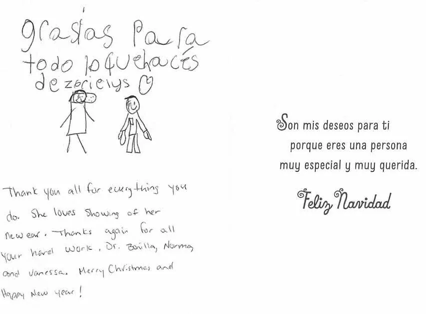 Tarjeta navideña bilingüe en español e inglés, con un dibujo infantil de figuras de palitos, firmada por Zarieys, que agradece al Dr. Arturo Bonilla su nueva oreja y le desea «Feliz Navidad»: un emotivo regalo por la celebración de una paciente agradecida que se sometió a cirugía de microtia y su familia